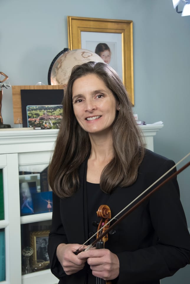 portrait of Christine Kilbride holding a violin and bow.